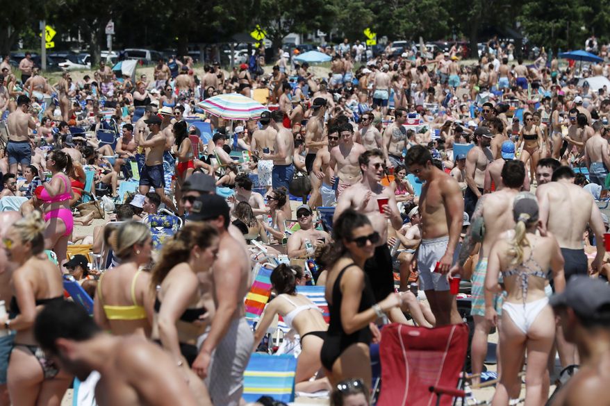Crowds gather on L Street Beach, Saturday, June 5, 2021, in the South Boston neighborhood of Boston. New England is giving the rest of the country a possible glimpse into the future if more Americans get vaccinated. The six-state region has among the highest vaccination rates in the U.S. and is seeing sustained drops in COVID-19 cases, hospitalizations and deaths. (AP Photo/Michael Dwyer) **FILE**