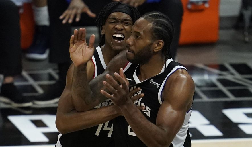 Los Angeles Clippers guard Terance Mann (14) and forward Kawhi Leonard (2) celebrate a shot during the fourth quarter of Game 7 of an NBA basketball first-round playoff series against the Dallas Mavericks Sunday, June 6, 2021, in Los Angeles, Calif. (AP Photo/Ashley Landis)