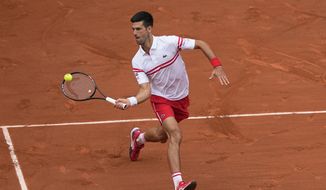 Serbia&#39;s Novak Djokovic plays a return to Italy&#39;s Lorenzo Musetti during their fourth round match on day 9, of the French Open tennis tournament at Roland Garros in Paris, France, Monday, June 7, 2021. (AP Photo/Michel Euler)
