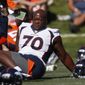 In this July 19, 2019, file photo, Denver Broncos offensive tackle Ja&#39;Wuan James (70) stretches during NFL football training camp in Englewood, Colo. James filed a $15 million grievance Monday, June 7, 2021, against the Broncos, who released him last month after he ruptured an Achilles during an off-site workout. (AP Photo/David Zalubowski, File) **FILE**