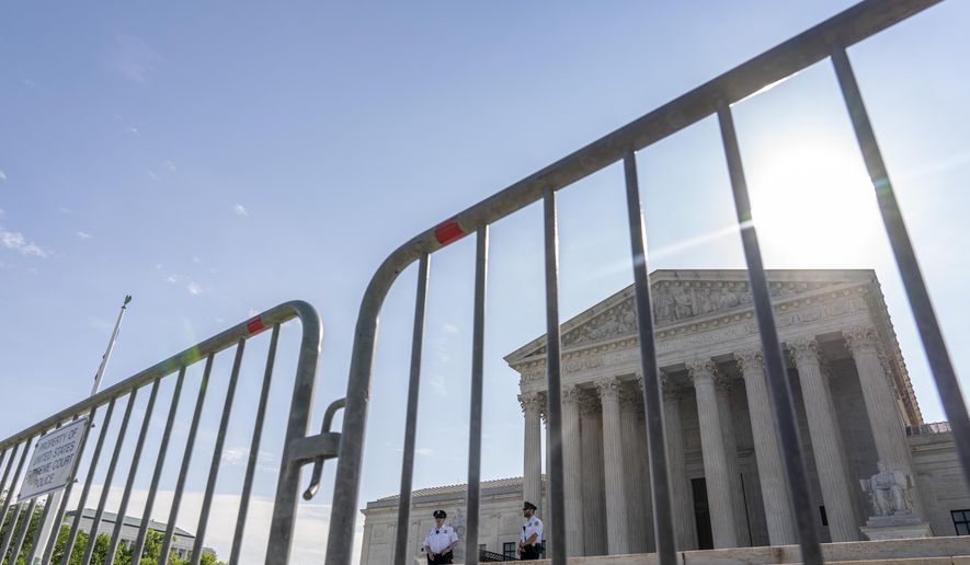 The Supreme Court is seen through a police barricade in Washington, Monday, June 7, 2021. (AP Photo/Andrew Harnik)