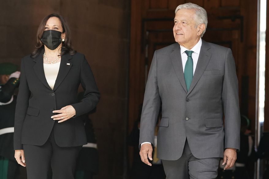 Vice President Kamala Harris walks with Mexican President Andres Manuel Lopez Obrador after arriving Tuesday, June 8, 2021, at the National Palace in Mexico City. (AP Photo/Jacquelyn Martin)