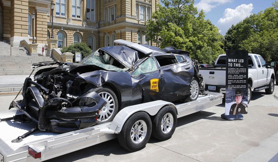 A wrecked Iowa State Patrol car sits on display during a news conference announcing the Iowa Traffic Fatality Reduction Task Force at the Iowa Capitol Building in Des Moines on Tuesday, June 8, 2021. (Bryon Houlgrave/The Des Moines Register via AP)/The Des Moines Register via AP) ** FILE **