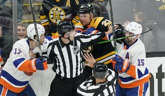 Referees keep Boston Bruins left wing Nick Ritchie (21) from fighting with New York Islanders left wing Matt Martin (17) and right wing Cal Clutterbuck (15) in the first period of Game 1 during an NHL hockey second-round playoff series, Saturday, May 29, 2021, in Boston. (AP Photo/Elise Amendola) **FILE**