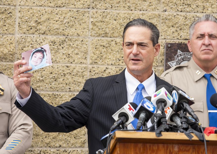 Orange County District Attorney Todd Spitzer holds up a photo of Aiden Leos during a news conference outside the CHP office in Santa Ana, Calif. on Monday, June 7, 2021 to update on the investigation into the shooting death of 6-year-old Aiden Leos. Officials should detail how they tied two suspects, a boyfriend and girlfriend from Costa Mesa, to the shooting. Marcus Anthony Eriz, 24, and Wynne Lee, 23, were arrested Sunday, June 6. (Leonard Ortiz/The Orange County Register via AP)