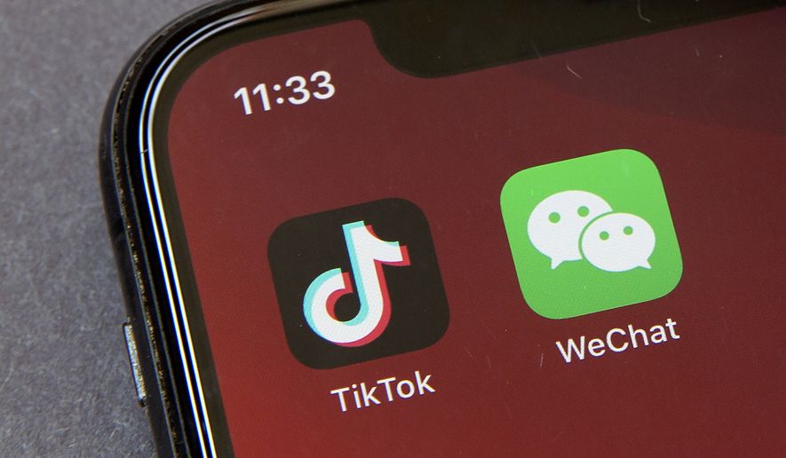 Icons for the smartphone apps TikTok and WeChat are seen on a smartphone screen in Beijing, in a Friday, Aug. 7, 2020 file photo.  Officials say the White House has dropped Trump-era executive orders that attempted to ban the popular apps TikTok and WeChat and will conduct its own review aimed at identifying national security risks with software applications tied to China. A new executive order directs the Commerce Department to undertake what officials describe as an “evidence-based” analysis of transactions involving apps that are manufactured or supplied or controlled by China. Officials are particularly concerned about apps that collect users’ personal data or have connections to Chinese military or intelligence activities. (AP Photo/Mark Schiefelbein, File)  **FILE**