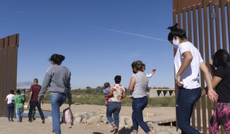 In this Tuesday, June 8, 2021, photo, a group of Brazilian migrants make their way around a gap in the U.S.-Mexico border in Yuma, Ariz., seeking asylum in the United States after crossing over from Mexico. The Biden administration says it has identified more than 3,900 children separated from their parents at the U.S.-Mexico border under former President Donald Trump&#x27;s &quot;zero-tolerance&quot; policy on illegal crossings. The Border Patrol&#x27;s Yuma sector recorded the highest number of separations of the agency&#x27;s nine sectors on the Mexican border. (AP Photo/Eugene Garcia) **FILE**