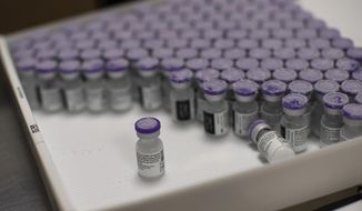 In this Monday, Jan. 4, 2021, photo, frozen vials of the Pfizer/BioNTech COVID-19 vaccine are taken out to thaw, at the MontLegia CHC hospital in Liege, Belgium. Envoys from World Trade Organization member nations are taking up a proposal to ease patents and other intellectual property protections for COVID-19 vaccines to help developing countries fight the pandemic, an idea backed by the Biden administration but opposed in other wealthy countries with strong pharmaceutical industries. On the table for a two-day meeting of a WTO panel opening Tuesday June 8, 2021, is a revised proposal presented by India and South Africa for a temporary IP waiver on coronavirus vaccines. (AP Photo/Francisco Seco) **FILE**
