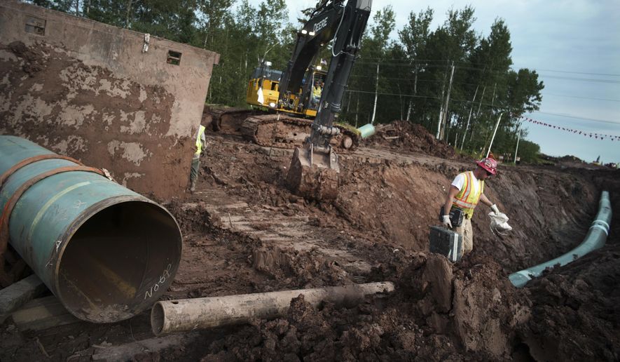 In this Aug. 21, 2017, photo, workers make sure that each section of the Enbridge replacement Line 3 that is joined passes muster in Superior, Wisc. The sponsor of the Keystone XL crude oil pipeline says it&#x27;s pulling the plug on the contentious project, Wednesday, June 9, 2021, after Canadian officials failed to persuade the Biden administration to reverse its cancellation of the company&#x27;s permit. (Richard Tsong-Taatarii/Star Tribune via AP) **FILE**