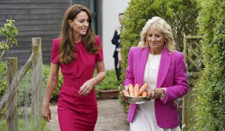 Britain&#x27;s Kate, Duchess of Cambridge, left, and U.S. first lady Jill Biden, carrying carrots for the school rabbit, Storm, during a visit to Connor Downs Academy in Hayle, West Cornwall, during the G-7 summit in England, Friday, June 11, 2021. (Aaron Chown/Pool photo via AP)