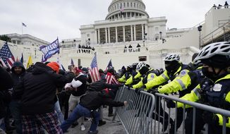 FILE - In this Jan. 6, 2021, file photo, Trump supporters try to break through a police barrier at the Capitol in Washington. A Chicago police officer has been charged with breaching the U.S. Capitol and entering a senator&#x27;s office during the Jan. 6 insurrection. Karol Chwiesiuk, was arrested Friday, June 11 and faces five misdemeanor counts, including entering a restricted building, disrupting government business, and disorderly conduct on Capitol grounds with intent to impede congressional proceeding. (AP Photo/Julio Cortez, File)