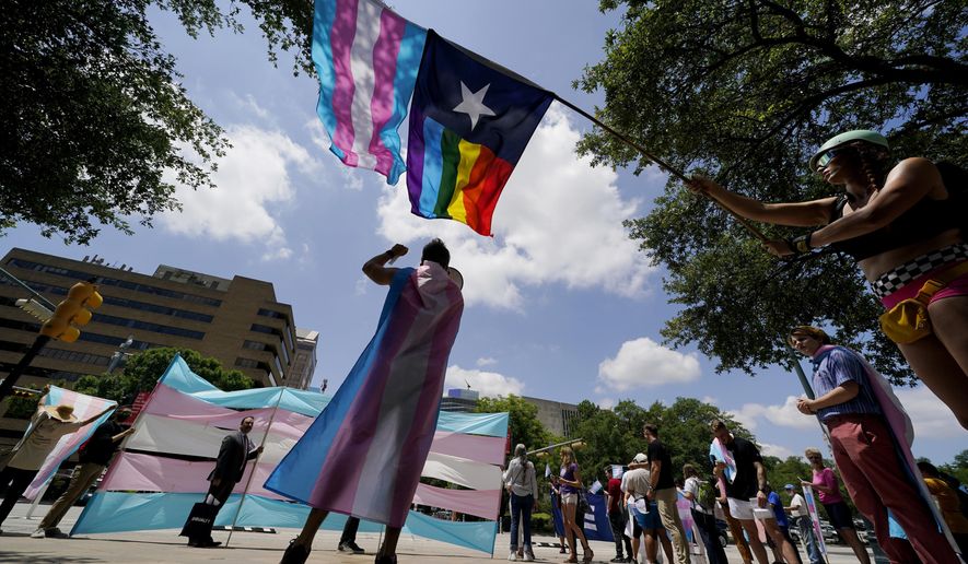 In this Thursday, May 20, 2021, photo, demonstrators gather on the steps to the State Capitol to speak against transgender-related legislation bills being considered in the Texas Senate and Texas House in Austin, Texas. Pride Month celebrations in the U.S. are taking place under unusual circumstances in June 2021, with pandemic-related concerns disrupting many of the usual festivities and political setbacks dampening the mood of LGBTQ-rights activists. (AP Photo/Eric Gay) **FILE**