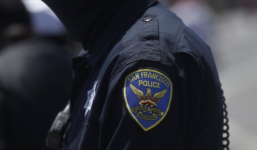 In this July 7, 2020, file photo a San Francisco Police Department patch is shown on an officer's uniform in San Francisco. Law enforcement agencies across the country experienced a wave of retirements and departures and are struggling to recruit the next generation of police officers in the year since George Floyd was killed by a cop. And amid the national reckoning on policing, communities are questioning who should become a police officer today. (AP Photo/Jeff Chiu, File)