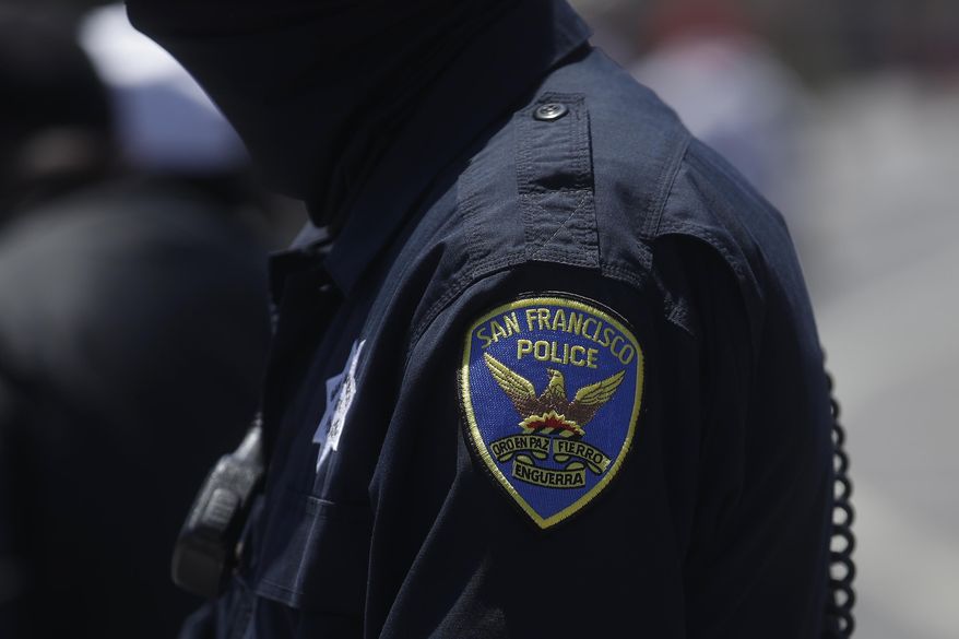 In this July 7, 2020, file photo a San Francisco Police Department patch is shown on an officer's uniform in San Francisco. Law enforcement agencies across the country experienced a wave of retirements and departures and are struggling to recruit the next generation of police officers in the year since George Floyd was killed by a cop. And amid the national reckoning on policing, communities are questioning who should become a police officer today. (AP Photo/Jeff Chiu, File)
