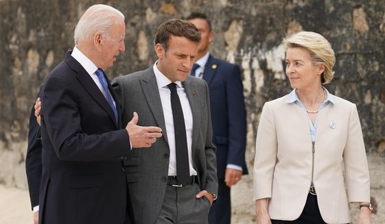 President Joe Biden speaks with French President Emmanuel Macron and European Commission President Ursula von der Leyen after posing for the G-7 family photo with guests at the G-7 summit, Friday, June 11, 2021, in Carbis Bay, England. (Kevin Lamarque/Pool via AP)