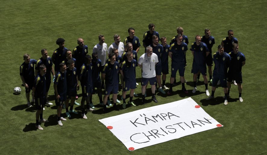 Swedish team pose next to a sign that reads &quot;Get Well Christian&quot; referring to Denmark&#39;s Christian Eriksen, during a training session at the La Cartuja stadium in Seville, Spain, Sunday, June 13, 2021. Sweden will play against Spain on Monday for the Group E of the Euro 2020 soccer championship. (Julio Munoz/Pool via AP)