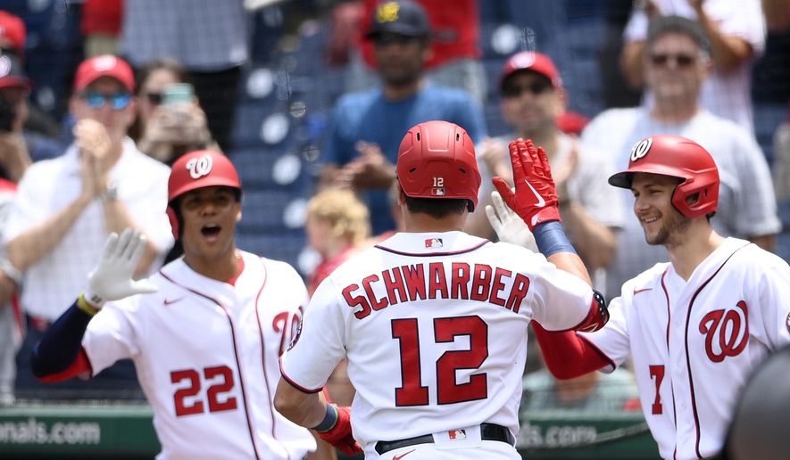 Washington Nationals&#x27; Kyle Schwarber celebrates his home run with Trea Turner (7) and Juan Soto (22) during the first inning of a baseball game against the San Francisco Giants, Sunday, June 13, 2021, in Washington. (AP Photo/Nick Wass)