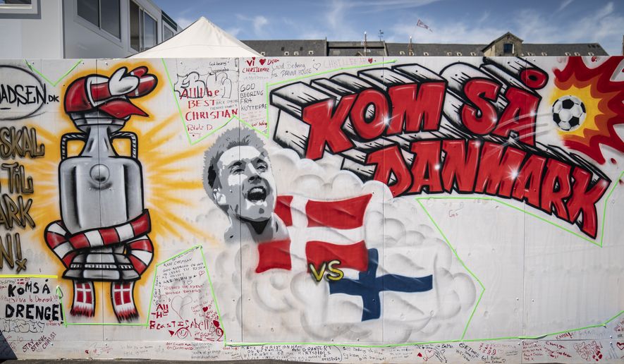 Messages to soccer player Christian Eriksen written on the wall at Football Village in Copenhagen, Monday June 14, 2021. The Denmark midfielder fell face-forward onto the field with cardiac arrest during the teams opening game against Finland on Saturday. Eriksen was resuscitated with a defibrillator and in a stable condition in a Copenhagen hospital on Monday. (Mads Claus Rasmussen/Ritzau Scanpix via AP)