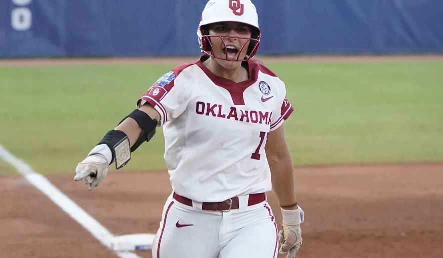 Oklahoma's Nicole Mendes (11) runs home with a home run in the first game of the NCAA Women's College World Series softball championship series against Florida State, Tuesday, June 8, 2021, in Oklahoma City. (AP Photo/Sue Ogrocki)