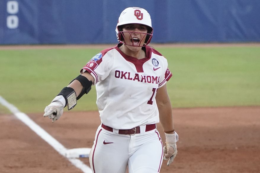Oklahoma&#39;s Nicole Mendes (11) runs home with a home run in the first game of the NCAA Women&#39;s College World Series softball championship series against Florida State, Tuesday, June 8, 2021, in Oklahoma City. (AP Photo/Sue Ogrocki)