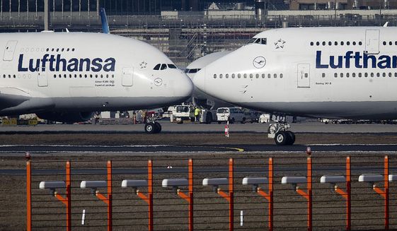 In this Feb.14, 2019, file photo, an Airbus A380, left, and a Boeing 747, both from Lufthansa airline pass each other at the airport in Frankfurt, Germany. The United States and the European Union on Tuesday appeared close to clinching a deal to end a damaging dispute over subsidies to Airbus and Boeing and lift billions of dollars in punitive tariffs. (AP Photo/Michael Probst, File)