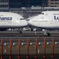 In this Feb.14, 2019, file photo, an Airbus A380, left, and a Boeing 747, both from Lufthansa airline pass each other at the airport in Frankfurt, Germany. The United States and the European Union on Tuesday appeared close to clinching a deal to end a damaging dispute over subsidies to Airbus and Boeing and lift billions of dollars in punitive tariffs. (AP Photo/Michael Probst, File)