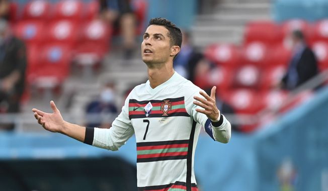 Portugal&#x27;s Cristiano Ronaldo reacts during the Euro 2020 soccer championship group F match between Hungary and Portugal at the Ferenc Puskas stadium in Budapest, Hungary, Tuesday, June 15, 2021. (Tibor Illyes/Pool via AP)