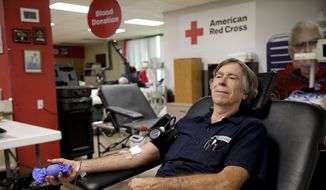 Mike Schneider donates blood at the Red Cross Blood Donation Center, Tuesday, June 15, 2021, in Tulsa, Okla. (Mike Simons/Tulsa World via AP) ** FILE **