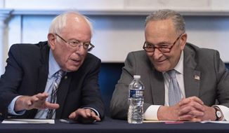 Senate Majority Leader Chuck Schumer of N.Y., right, sits next to Sen. Bernie Sanders, I-Vt., during a meeting with Senate Democrats on the Budget Committee, Wednesday, June 16, 2021, on Capitol Hill in Washington. (AP Photo/Jacquelyn Martin)