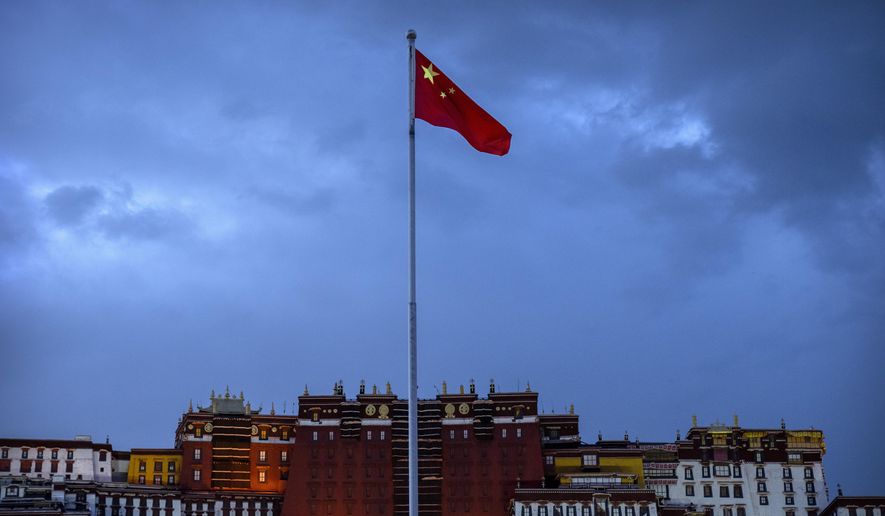 The Chinese flag flies at a plaza near the Potala Palace in Lhasa in western China&#39;s Tibet Autonomous Region, Tuesday, June 1, 2021, as seen during a government organized visit for foreign journalists. High-pressure tactics employed by China&#39;s ruling Communist Party appear to be finding success in separating Tibetans from their traditional Buddhist culture and the influence of the Dalai Lama. (AP Photo/Mark Schiefelbein)