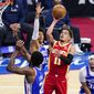 Atlanta Hawks&#x27; Trae Young (11) goes up for a shot against Philadelphia 76ers&#x27; Joel Embiid (21), Matisse Thybulle (22) and Seth Curry (31) during the second half of Game 5 in a second-round NBA basketball playoff series, Wednesday, June 16, 2021, in Philadelphia. (AP Photo/Matt Slocum)