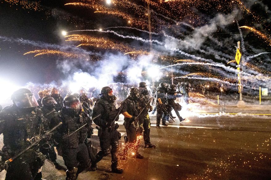 Police use chemical irritants and crowd control munitions to disperse protesters during a demonstration in Portland, Oregon, Sept. 5, 2020. (AP Photo/Noah Berger) **FILE**