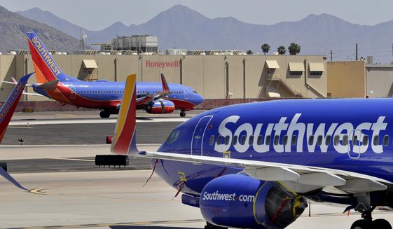 In this Tuesday, April 28, 2020, file photo, Southwest Airlines jets are stored at Sky Harbor International Airport in Phoenix. (AP Photo/Matt York, File)