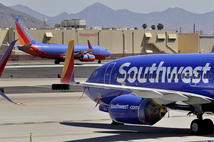 In this Tuesday, April 28, 2020, file photo, Southwest Airlines jets are stored at Sky Harbor International Airport in Phoenix. (AP Photo/Matt York, File)