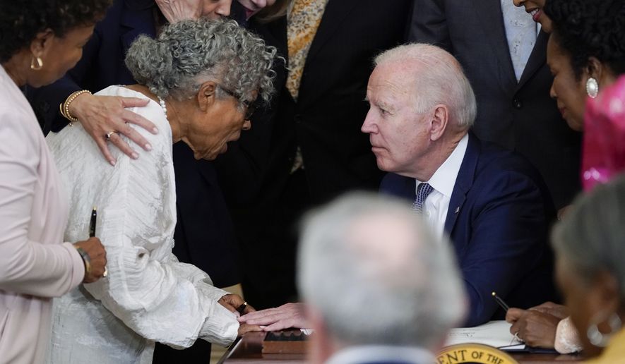 President Joe Biden speaks with Opal Lee after he signed the Juneteenth National Independence Day Act, in the East Room of the White House, Thursday, June 17, 2021, in Washington. (AP Photo/Evan Vucci)