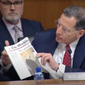 Sen. John Barrasso, Wyoming Republican, reads from Thursday’s front-page article in The Washington Times, “Tree spiking case haunts nominee for public lands.” (Screengrab via https://www.youtube.com/watch?v=69lPYIUE9_E)