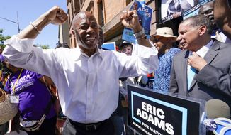 Democratic mayoral candidate Eric Adams, left, is joined by former Gov. David Paterson, right, during a campaign event, Thursday, June 17, 2021, in the Harlem neighborhood of New York. Wright and Paterson endorsed Adams. (AP Photo/Mary Altaffer)