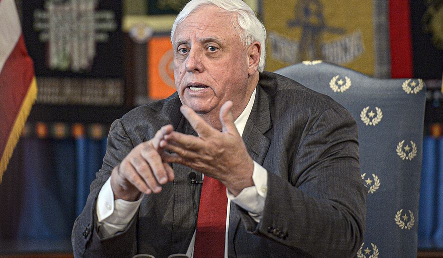 In this March 12, 2020, file photo, West Virginia Gov. Jim Justice speaks during a press conference at the State Capitol in Charleston, W.Va. The U.S. Department of Justice has weighed in on a new West Virginia law that bans transgender athletes from competing in female sports, asserting in a court filing Thursday, June 17, 2021, that the ban violates federal law.  Justice signed the bill despite warnings from some lawmakers that the NCAA could retaliate and decide not to hold college tournaments in the state. Justice had said that while it concerned him that the state could miss out on a sporting event, he believed the benefits of the law “way outweigh the bad part of it.” (F. Brian Ferguson/Charleston Gazette-Mail via AP, File)