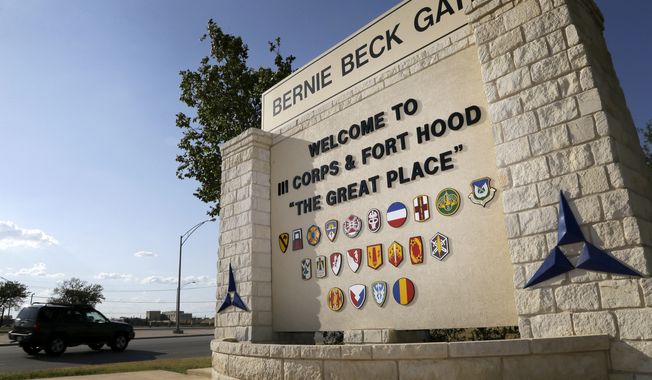 In this July 9, 2013, photo, traffic flows through the main gate past a welcome sign in Fort Hood, Texas. A new study finds that female soldiers at Army bases in Texas, Colorado, Kansas and Kentucky face a greater risk of sexual assault and harassment than those at other posts, accounting for more than a third of all active-duty Army women sexually assaulted in 2018. (AP Photo/Tony Gutierrez) **FILE**