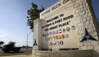 In this July 9, 2013, photo, traffic flows through the main gate past a welcome sign in Fort Hood, Texas. A new study finds that female soldiers at Army bases in Texas, Colorado, Kansas and Kentucky face a greater risk of sexual assault and harassment than those at other posts, accounting for more than a third of all active-duty Army women sexually assaulted in 2018. (AP Photo/Tony Gutierrez) **FILE**
