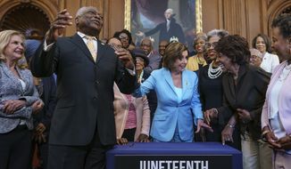 House Majority Whip James Clyburn, D-S.C., left, celebrates with Speaker of the House Nancy Pelosi and members of the Congressional Black Caucus after passage of the Juneteenth National Independence Day Act that creates a new federal holiday to commemorate June 19, 1865, when Union soldiers brought the news of freedom to enslaved Black people after the Civil War, at the Capitol in Washington, Thursday, June 17, 2021. It&#39;s the first new federal holiday since Martin Luther King Jr. Day was created in 1983. (AP Photo/J. Scott Applewhite)
