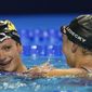 Katie Ledecky congratulates Katie Grimes after the women&#x27;s 800 freestyle during wave 2 of the U.S. Olympic Swim Trials on Saturday, June 19, 2021, in Omaha, Neb. (AP Photo/Jeff Roberson)