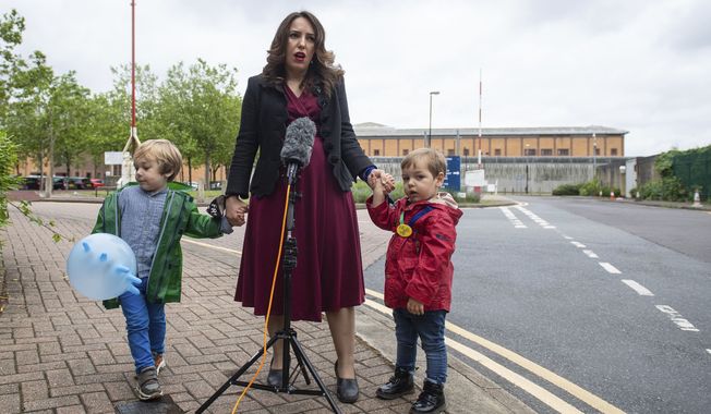 Stella Moris stands with her children Gabriel, four, left, and Max, two, as she speaks to the media, outside Belmarsh Prison, following a visit to her partner and their father Julian Assange in London, Saturday June 19, 2021.  Assange is being detained in Belmarsh prison in London while the US continues an attempt to extradite him under the US&#x27;s 1917 Espionage Act for &quot;unlawfully obtaining and disclosing classified documents related to the national defence&quot;. (Dominic Lipinski/PA via AP)