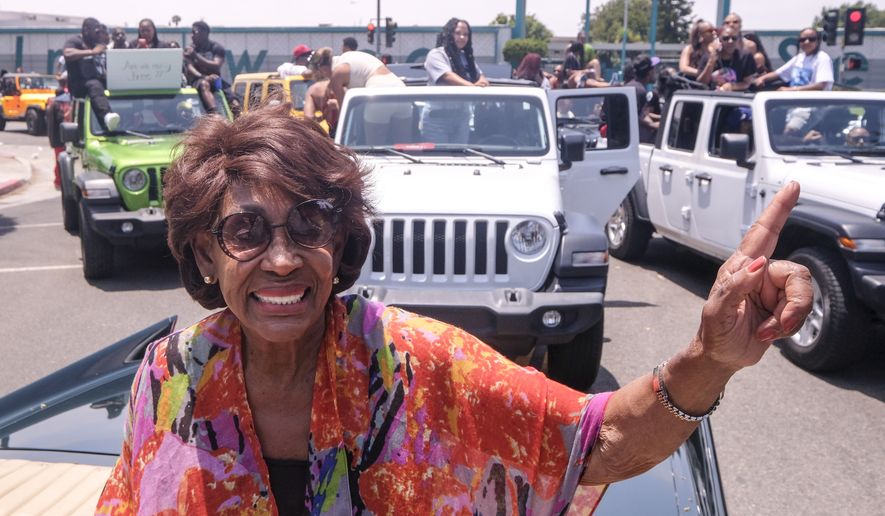 Congresswoman Maxine Waters waves in her car during a car parade to mark Juneteenth on Saturday, June 19, 2021, in Inglewood, Calif. (AP Photo/Ringo H.W. Chiu)