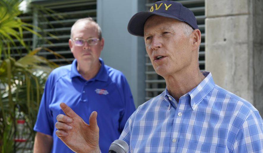 Senator Rick Scott, R-Fla., right, speaks during a news conference after having toured the National Hurricane Center with director Ken Graham, left, Tuesday, June 1, 2021, at the center in Miami. Tuesday marks the start of the 2021 Atlantic hurricane season which runs to Nov. 30. (AP Photo/Wilfredo Lee)