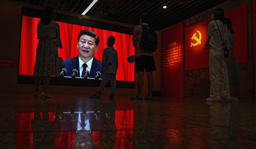 Visitors watch a screen showing Chinese President Xi Jinping speaking next to a Communist Party&#39;s flag, at an exhibition promoting China&#39;s achievement under communist party from 1921 to 2021, in Beijing, Sunday, June 20, 2021. Authorities are gearing up to mark the 100th anniversary of the founding of China&#39;s ruling Communist Party, which will be observed on July 1. (AP Photo/Andy Wong)
