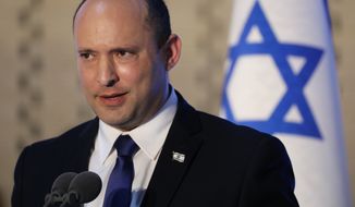 Israeli Prime Minister Naftali Bennett, speaks during a memorial ceremony for Israeli soldiers who fell in battle during the 2014 Gaza War, in the Hall of Remembrance at Mount Herzl Military Cemetery in Jerusalem, Israel, Sunday, June 20, 2021. (Abir Sultan/Pool Photo via AP)
