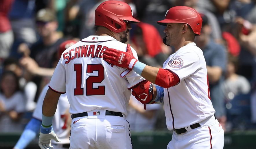 Washington Nationals&#x27; Kyle Schwarber (12) celebrates his two-run home run with Gerardo Parra, right, during the seventh inning of a baseball game against the New York Mets, Sunday, June 20, 2021, in Washington. (AP Photo/Nick Wass)