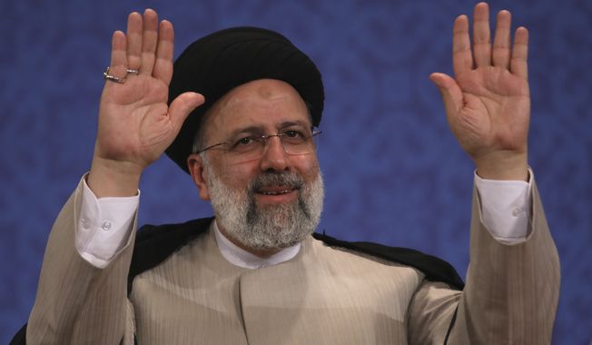 Iran&#x27;s new President-elect Ebrahim Raisi waves to participants at the conclusion of his press conference in Tehran, Iran, Monday, June 21, 2021. Raisi said Monday he wouldn&#x27;t meet with President Joe Biden nor negotiate over Tehran&#x27;s ballistic missile program and its support of regional militias, sticking to a hard-line position following his landslide victory in last week&#x27;s election. (AP Photo/Vahid Salemi)