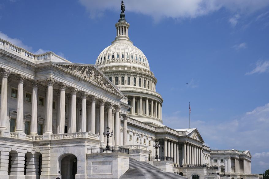 In this June 14, 2021, file photo the U.S. Capitol is seen in Washington as the House and Senate return to work. Congress is hunkered down, grinding through an eight-week stretch as the president’s Democratic allies in the House and Senate try to shape his big infrastructure ideas into bills that could actually be signed into law. Perhaps not since the drafting of Obamacare more than a decade ago has Washington tried a legislative lift as heavy as this. (AP Photo/J. Scott Applewhite, File)